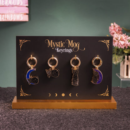 Mystic Mog Pack of 24 Cat-Themed Enamel Keyrings ? Crescent Moon, Sitting Cat, and Sleeping Cat Designs with Display Stand by Something Different HK